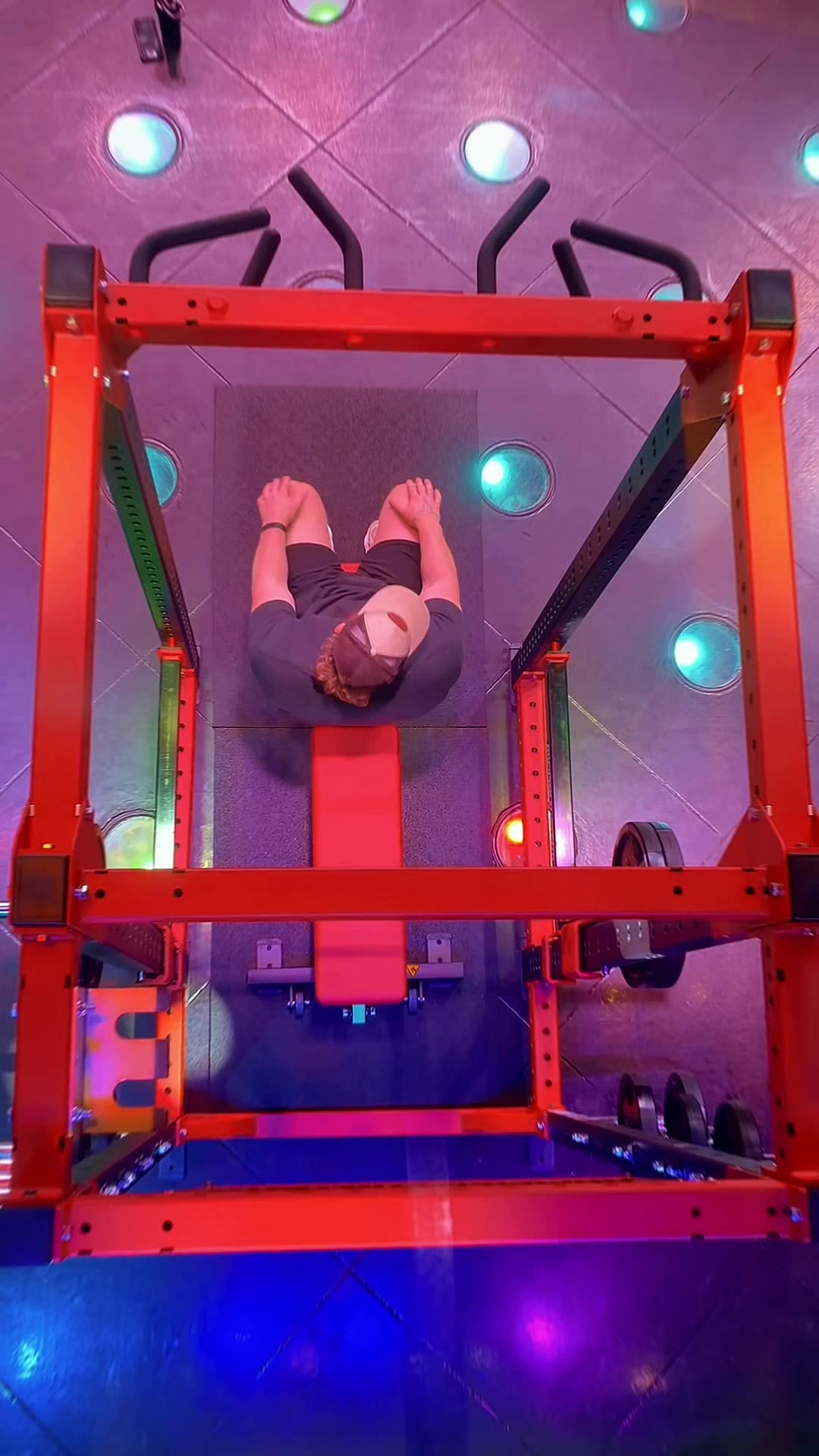 Overhead view of a bench press, coloured ceiling lights overhead at Wabash Iron