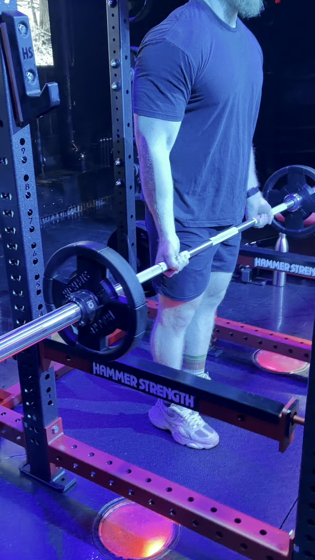 Lifter working with a loaded barbell on the purple-lit floor at Wabash Iron