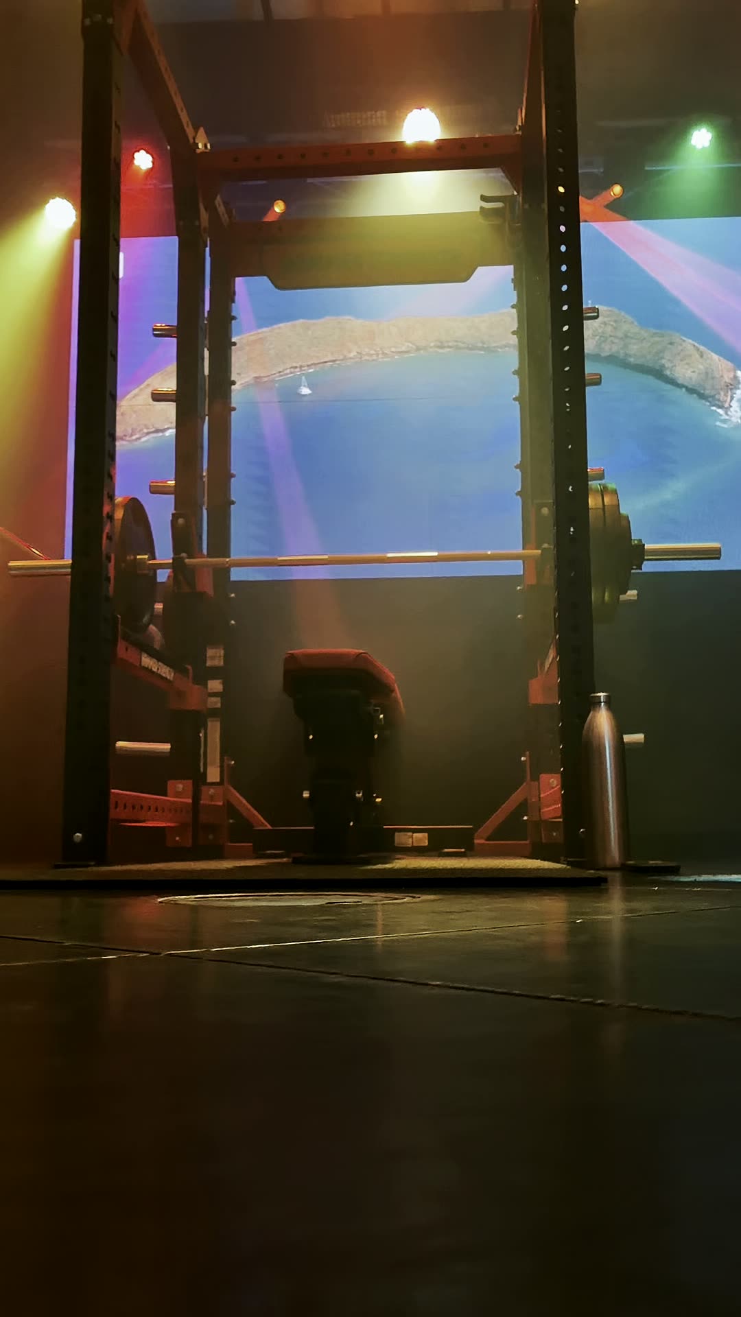 Coloured stage lighting washing across the training floor and LED panel at Wabash Iron